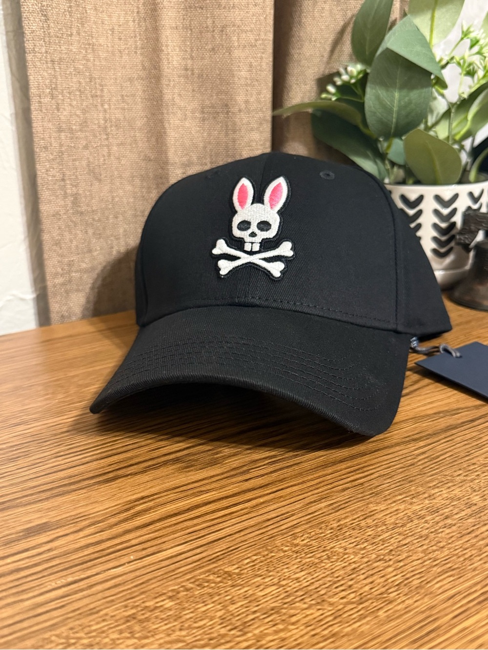 Psycho Bunny Black Cap with White Skull and Pink Ear Accents